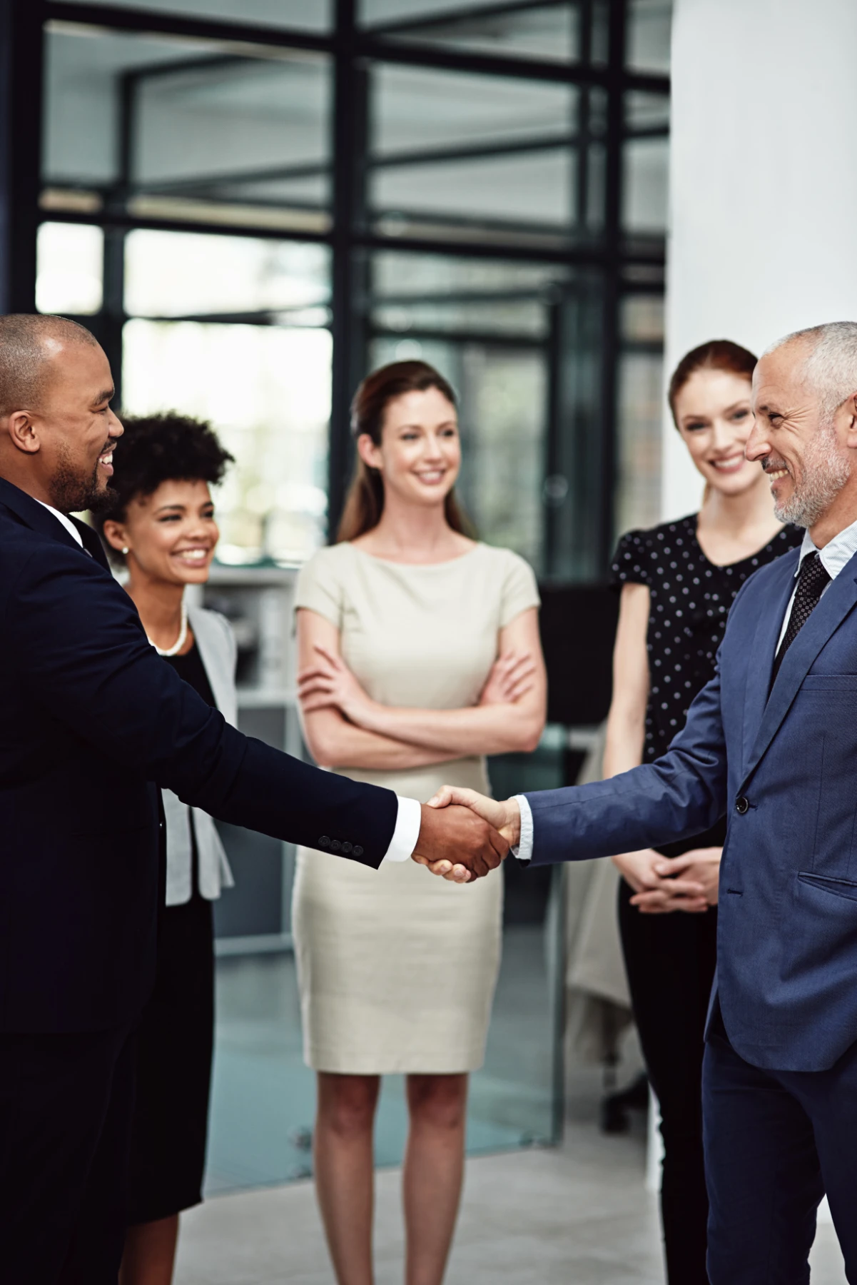 Business Professionals Shaking Hands in a Bright Office