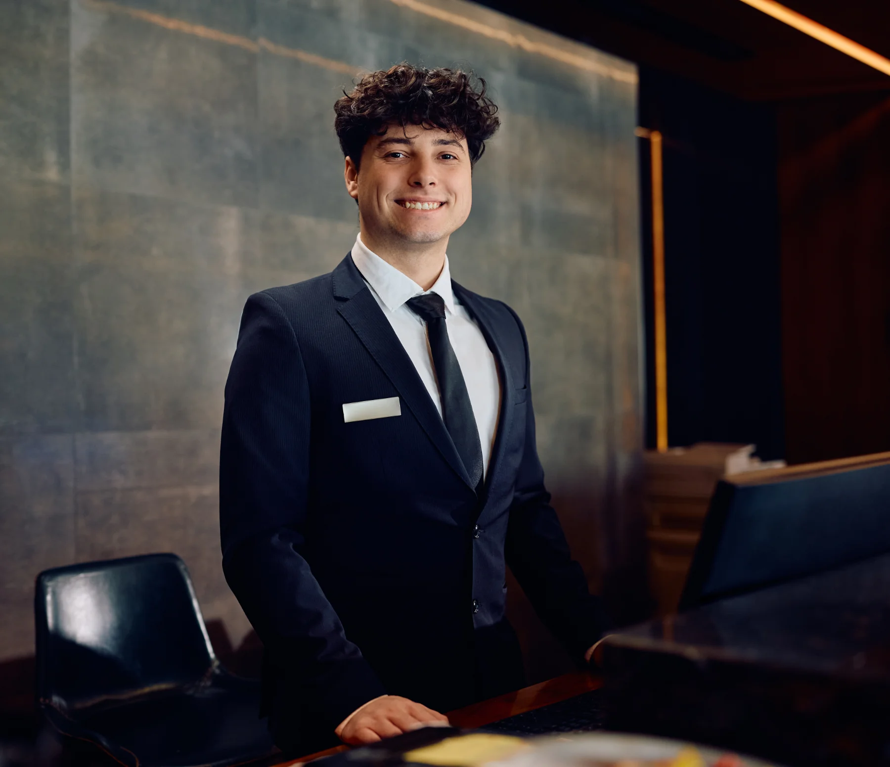 Portrait of happy hotel receptionist looking at camera.
